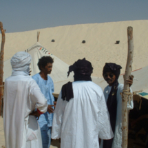 Members of the musical group Tinariwen, standing in the sands of the Sahara desert. The group performed at the Festival in the Desert, an annual event in Mali that brings musicians (and others) from around the world to the farthermost regions of the country. The 2003 festival took place in Essakane, Mali. Stories on the festival appeared in the San Francisco Chronicle and a London magazine called The Wire.